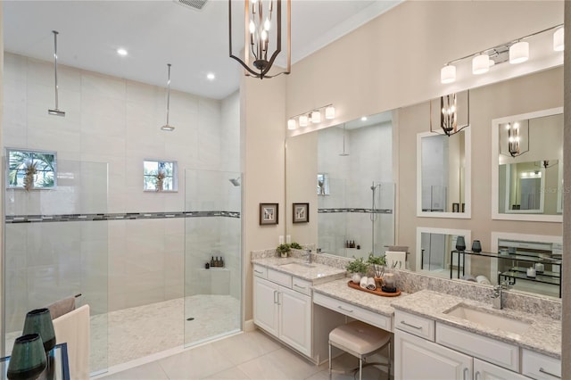 bathroom with tiled shower, vanity, ornamental molding, and tile patterned flooring