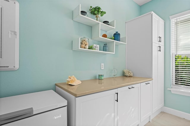 laundry area featuring light tile patterned floors