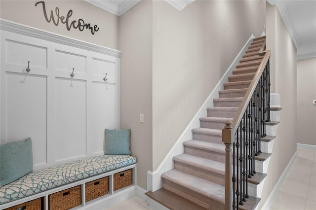 mudroom featuring light tile patterned floors and crown molding