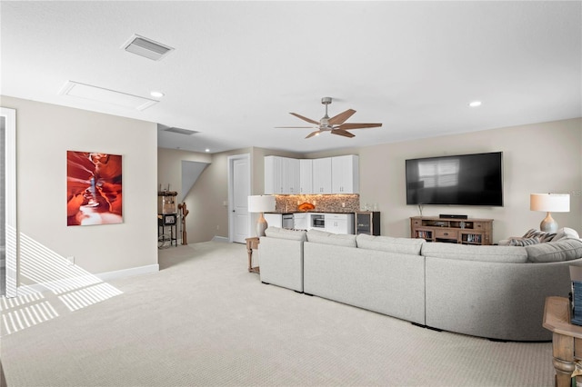 carpeted living room featuring ceiling fan