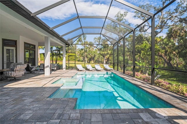 view of swimming pool with glass enclosure and a patio area