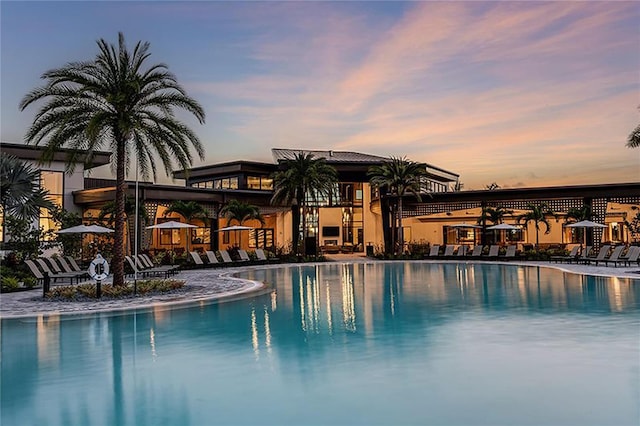 view of pool at dusk