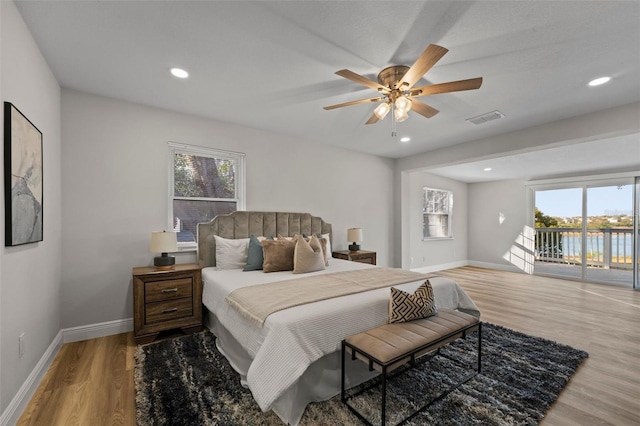 bedroom featuring ceiling fan, access to exterior, and hardwood / wood-style floors