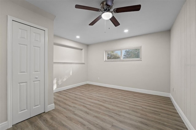 unfurnished bedroom with ceiling fan, light hardwood / wood-style floors, and a closet