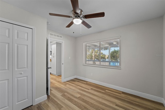 unfurnished bedroom with ceiling fan, a closet, and light hardwood / wood-style floors