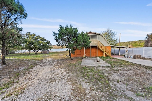 exterior space featuring a water view and a carport