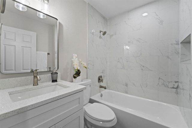 full bathroom featuring toilet, tiled shower / bath combo, and vanity