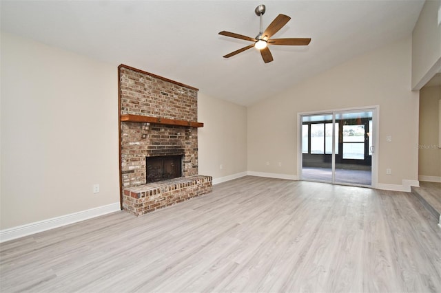 unfurnished living room featuring ceiling fan, vaulted ceiling, light hardwood / wood-style flooring, and a fireplace