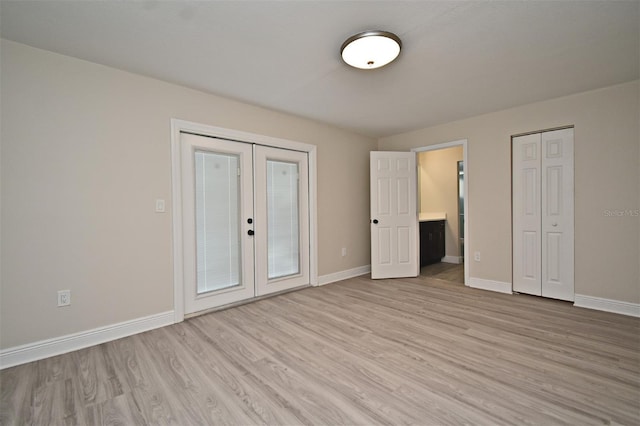 unfurnished bedroom featuring light hardwood / wood-style floors and french doors