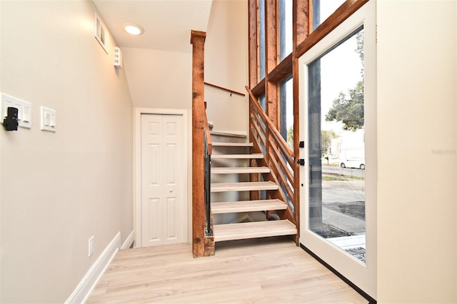 stairs featuring wood-type flooring