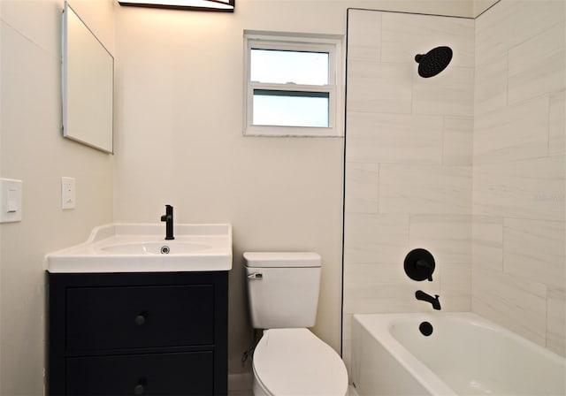 full bathroom with toilet, vanity, and tiled shower / bath combo