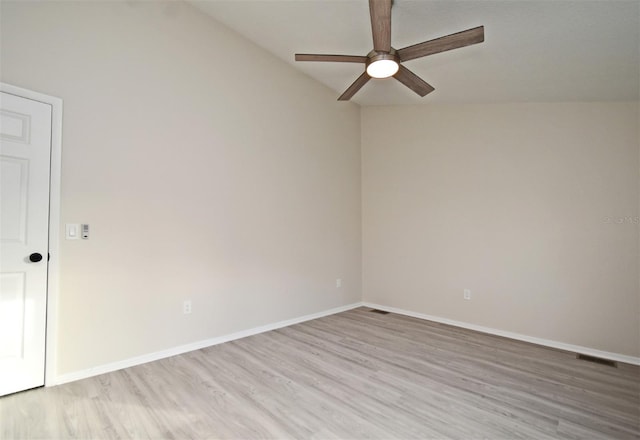 empty room featuring ceiling fan, lofted ceiling, and light wood-type flooring