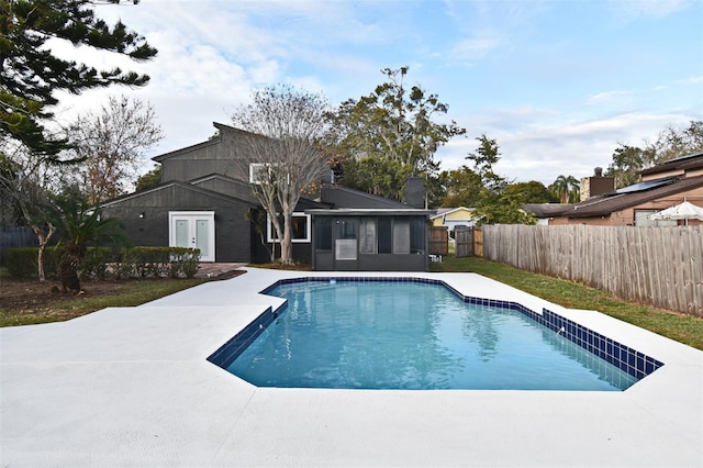 view of swimming pool featuring french doors