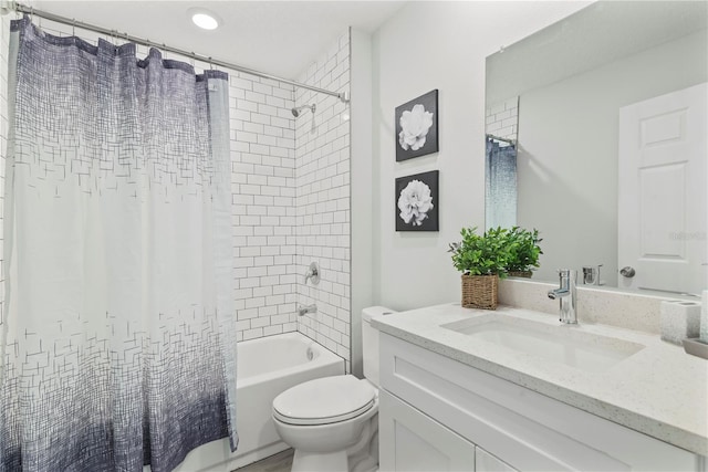 full bathroom featuring toilet, vanity, and shower / tub combo