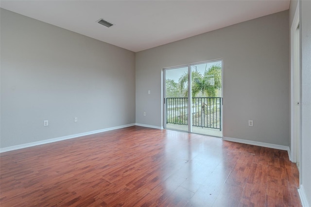 empty room with dark hardwood / wood-style floors