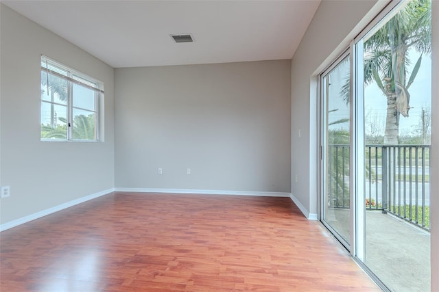 empty room featuring hardwood / wood-style flooring and a water view