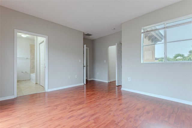 empty room with hardwood / wood-style flooring