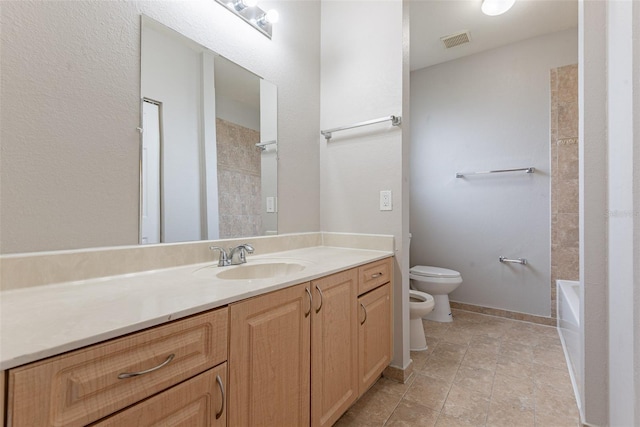 bathroom featuring a bidet, vanity, and toilet