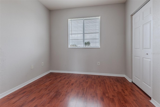 unfurnished bedroom featuring dark hardwood / wood-style floors