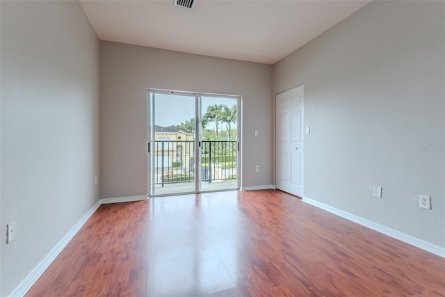 spare room with hardwood / wood-style flooring