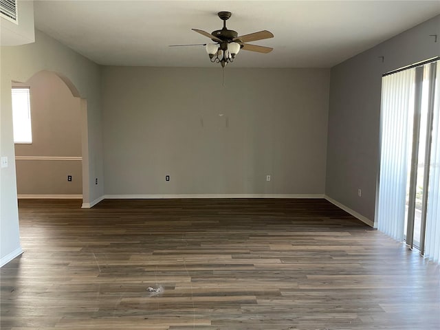 spare room with dark hardwood / wood-style floors and ceiling fan