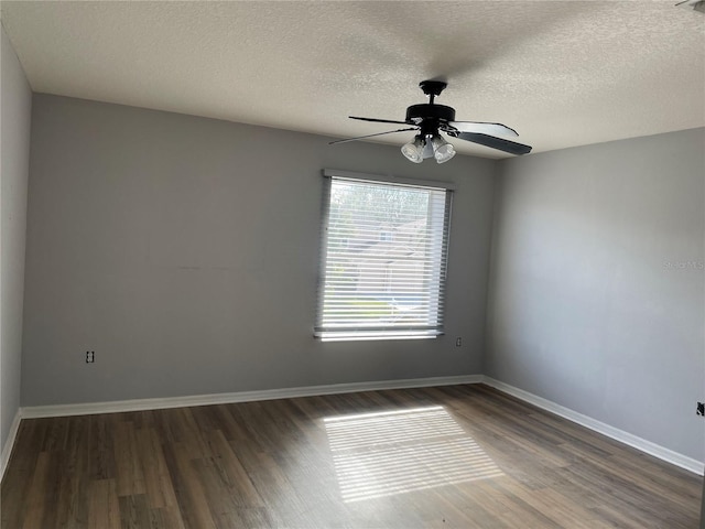 spare room with ceiling fan, dark hardwood / wood-style floors, and a textured ceiling