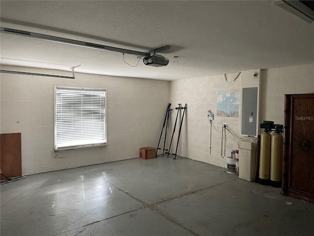 garage with a garage door opener and electric panel