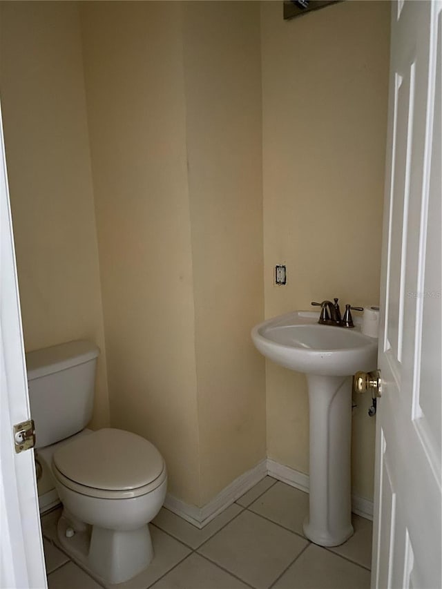 bathroom featuring tile patterned flooring, sink, and toilet