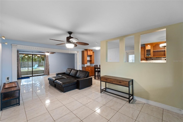 tiled living room with ceiling fan