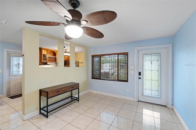 tiled entrance foyer featuring ceiling fan