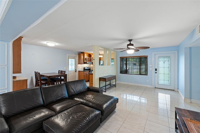 living room with ceiling fan and a wealth of natural light