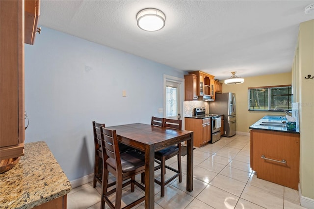 tiled dining area featuring sink