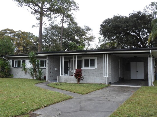 ranch-style home featuring a front yard and a carport