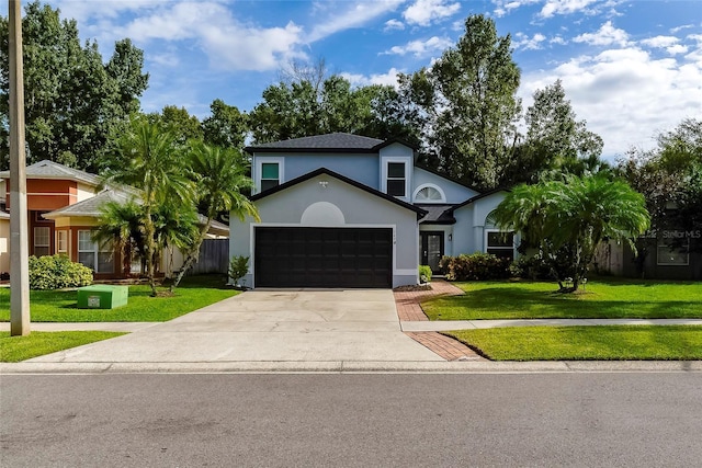 view of front of home with a garage and a front yard