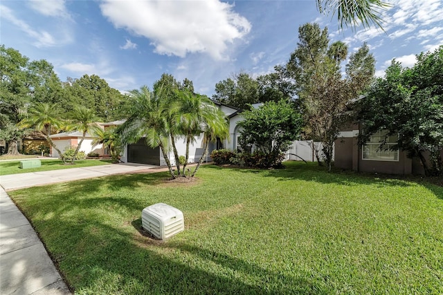 view of front of property with a garage and a front lawn