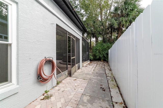 view of side of property with a patio