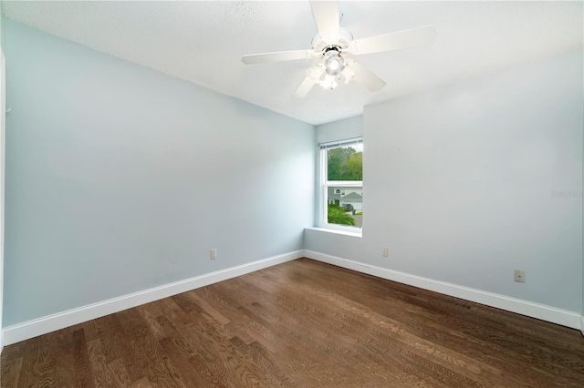 spare room with ceiling fan and wood-type flooring