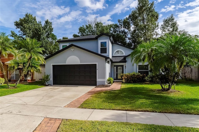 view of front of home with a front lawn and a garage