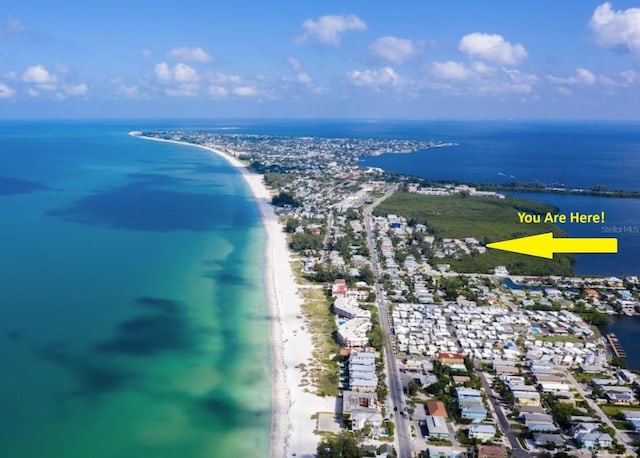 aerial view with a water view and a beach view