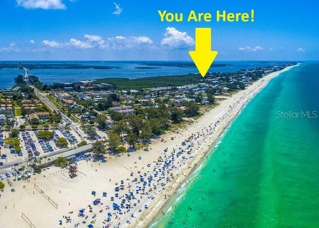 drone / aerial view featuring a water view and a beach view