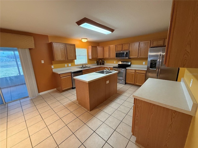 kitchen with light tile patterned flooring, stainless steel appliances, a kitchen island, and a wealth of natural light