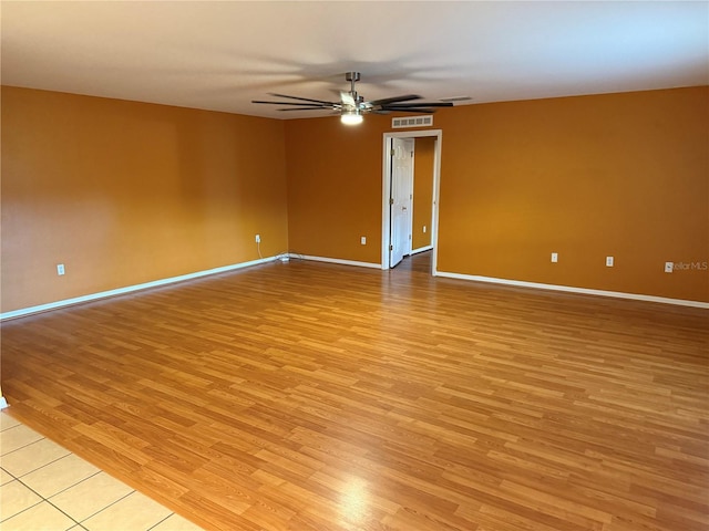 empty room featuring ceiling fan and light wood-type flooring