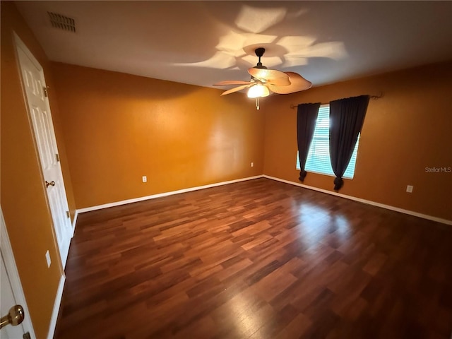 unfurnished room with ceiling fan and dark hardwood / wood-style flooring