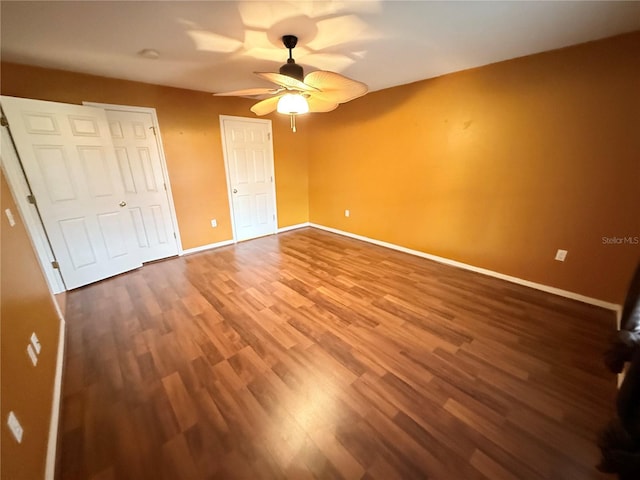 unfurnished bedroom featuring hardwood / wood-style floors and ceiling fan