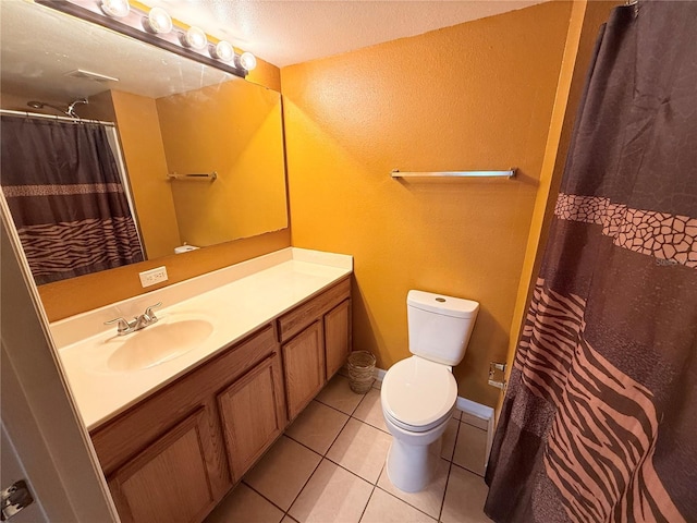 bathroom featuring toilet, a textured ceiling, vanity, a shower with shower curtain, and tile patterned flooring