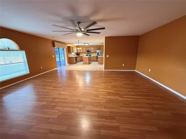 unfurnished living room featuring light hardwood / wood-style floors and ceiling fan