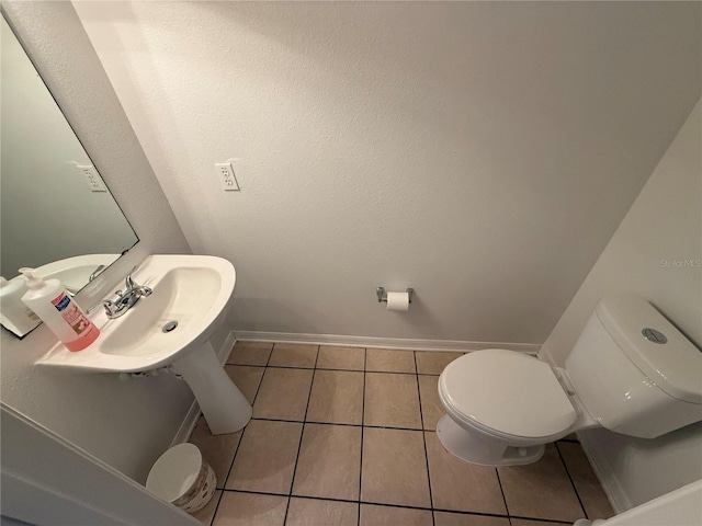 bathroom with tile patterned flooring, sink, and toilet