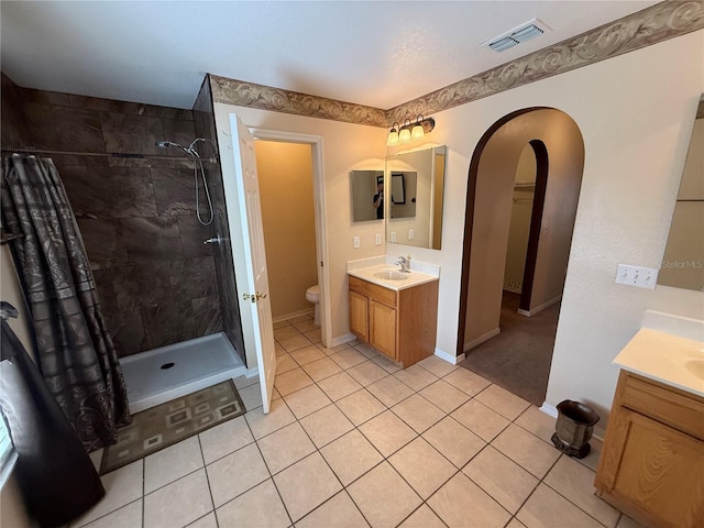 bathroom with vanity, tile patterned flooring, a shower with curtain, and toilet