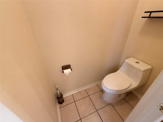 bathroom with tile patterned flooring and toilet