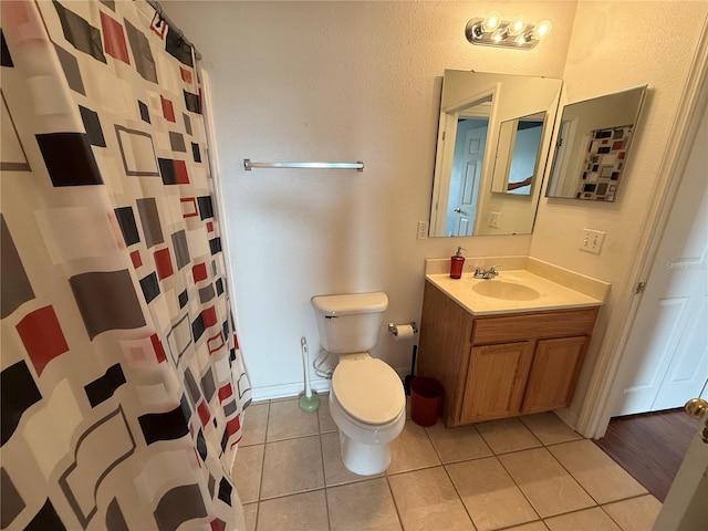 bathroom with vanity, toilet, curtained shower, and tile patterned flooring